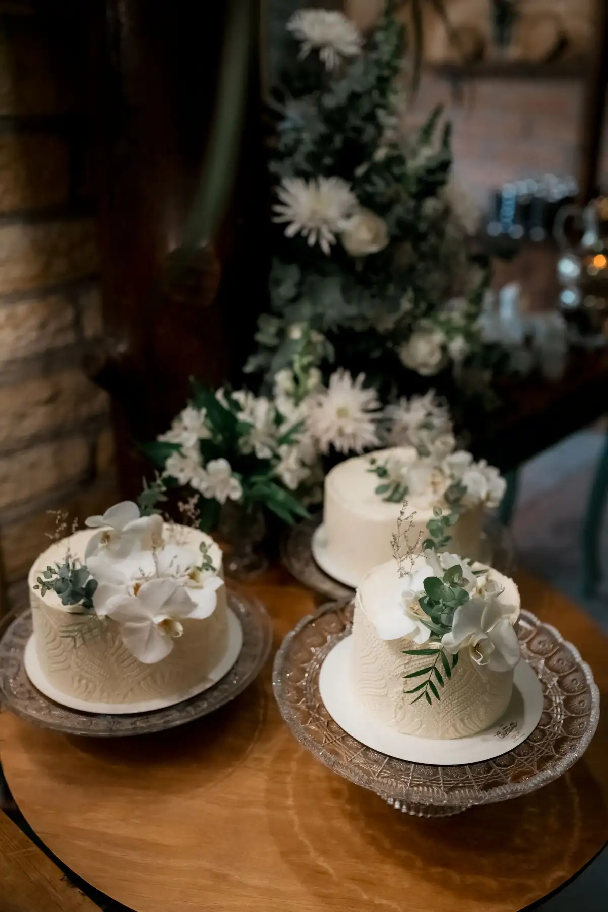 Two small iced cakes finished with fresh flowers