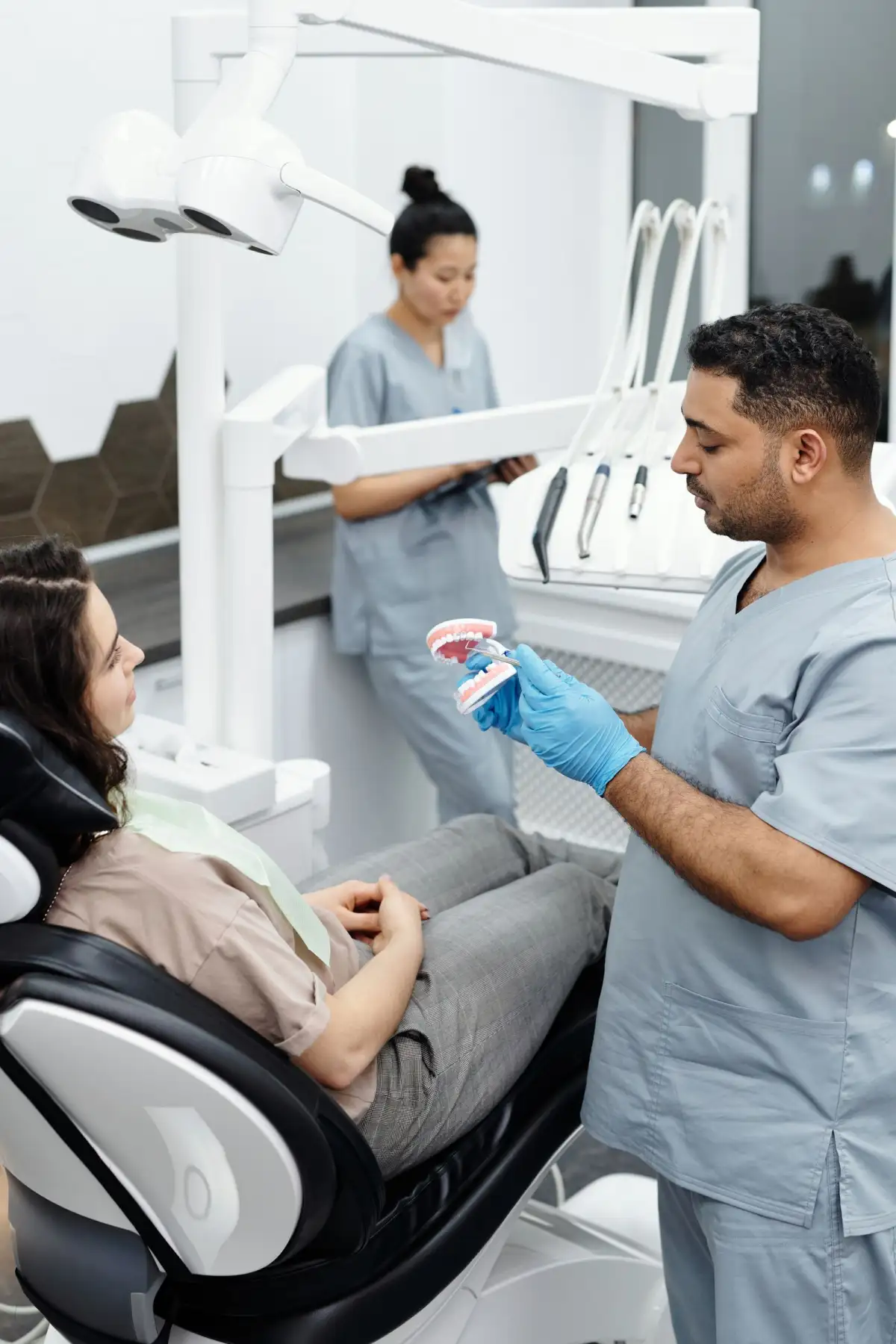 A dentist talking a patient through what the photograph shows