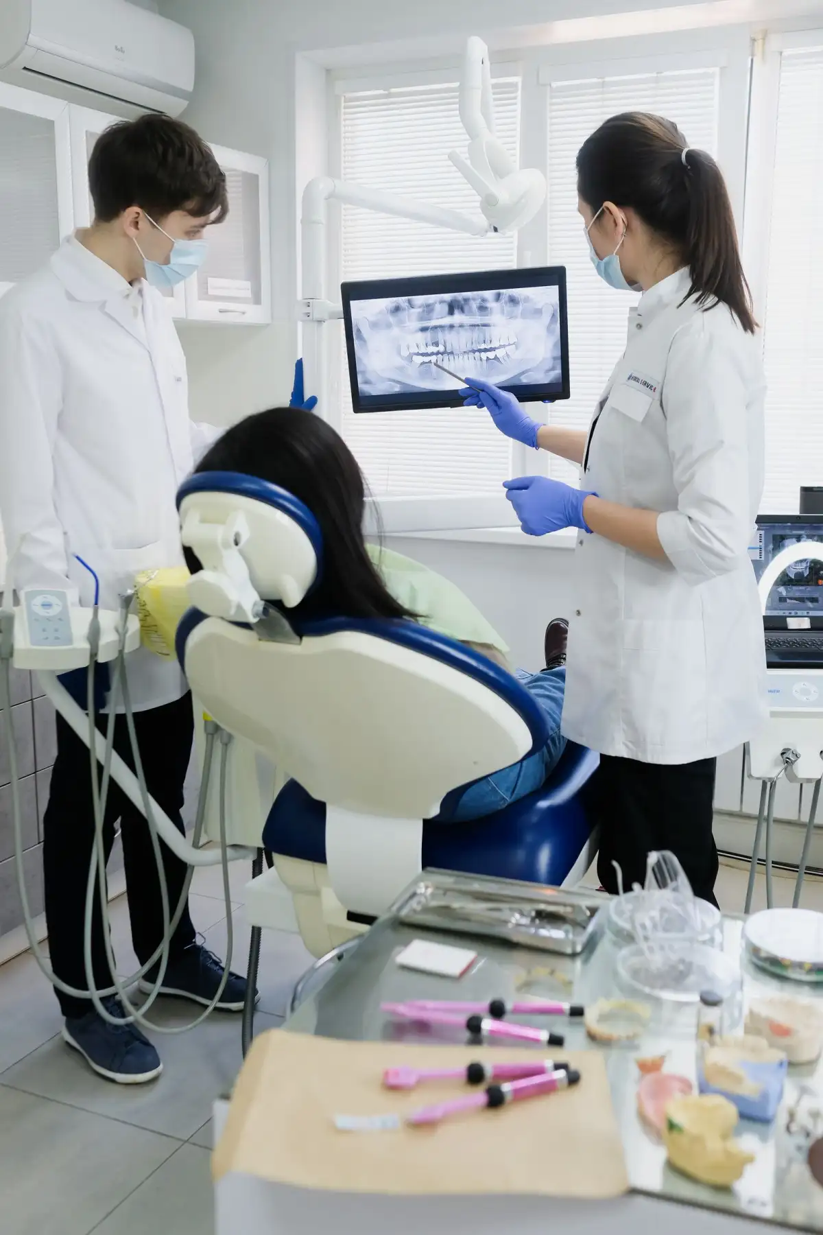 A radiograph on the screen beside the chair during an appointment