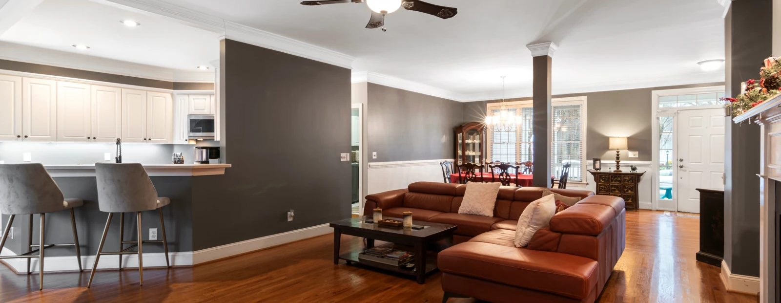 An open-plan kitchen and living room with recessed lighting