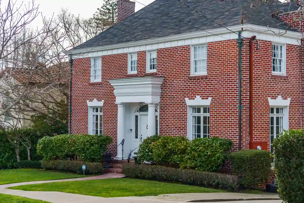 A brick colonial house with white trim