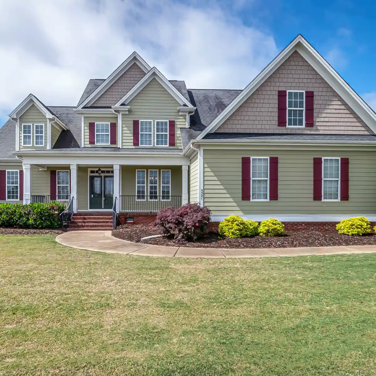 A two-story house with red shutters