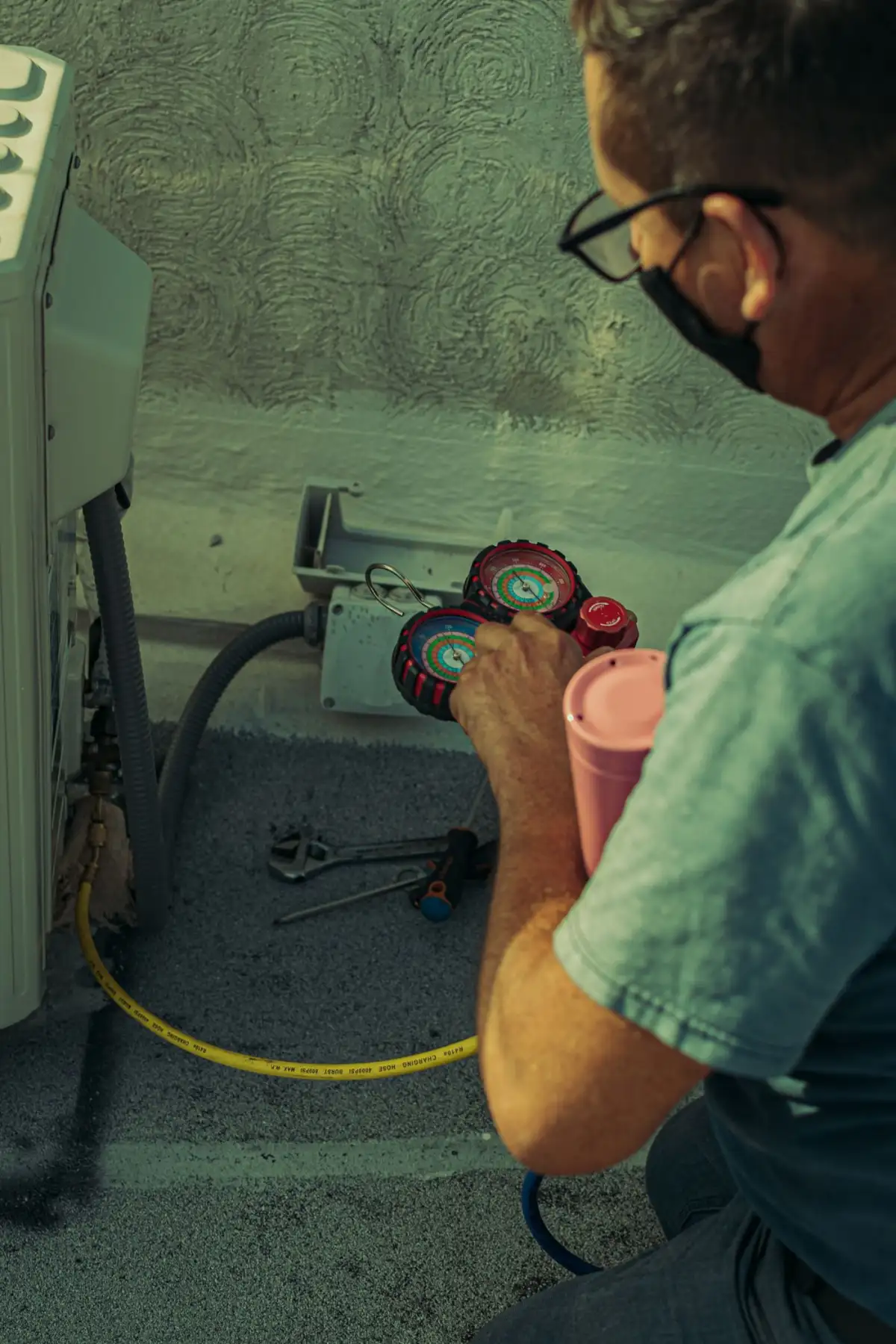 A technician working an outdoor unit