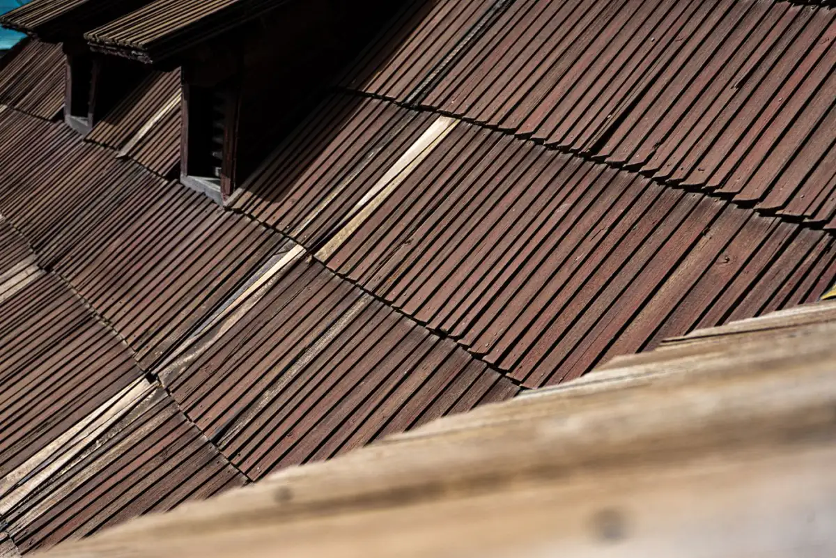 Weathered asphalt shingle courses at close range